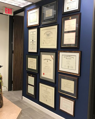 Dr. Malena Amato's framed diplomas at her oculoplastic facial surgery clinic